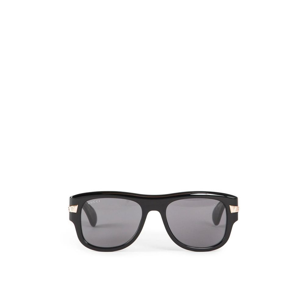 Black Gucci sunglasses with dark lenses and gold detailing on the temples