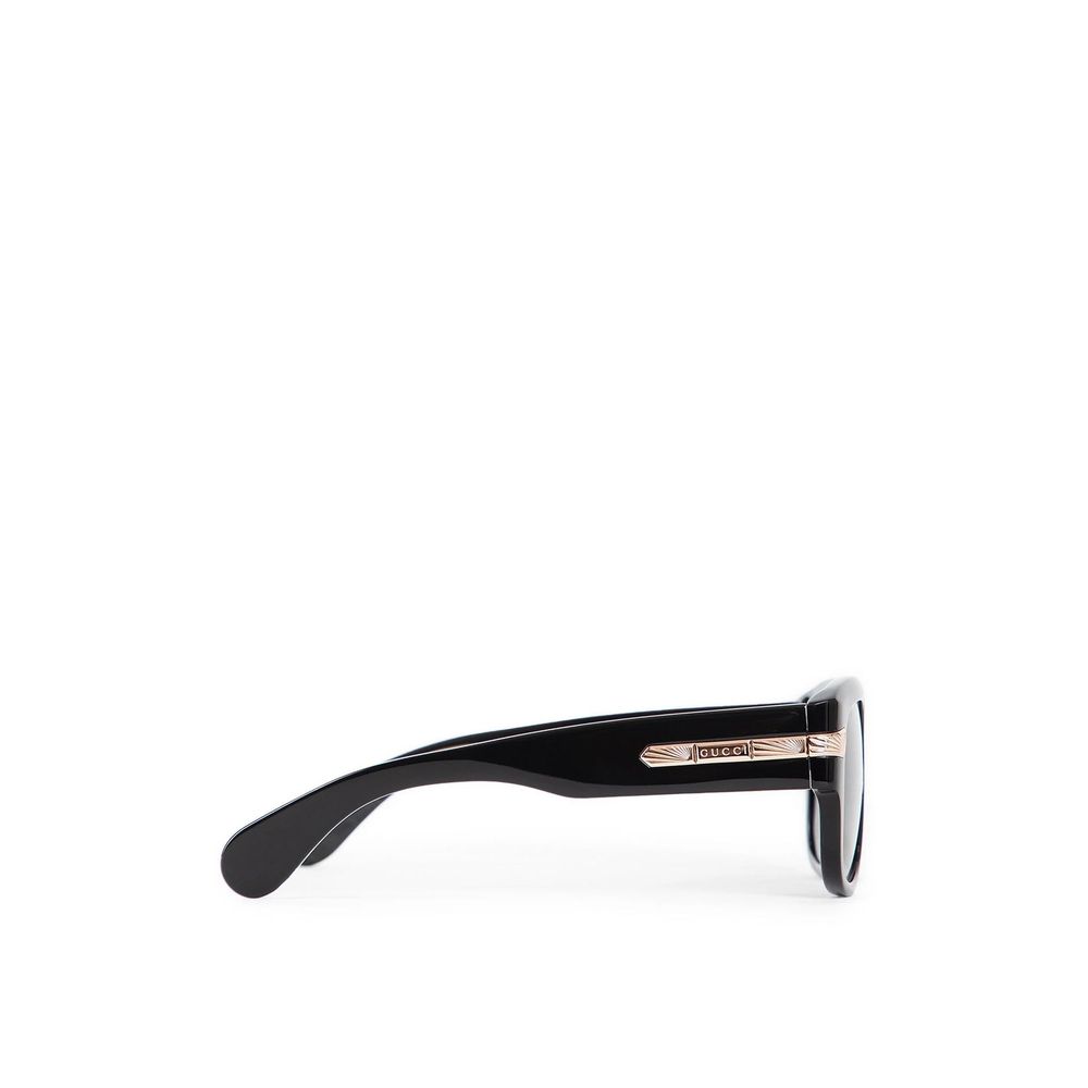 Black Gucci sunglasses with dark lenses and gold detailing on the temples