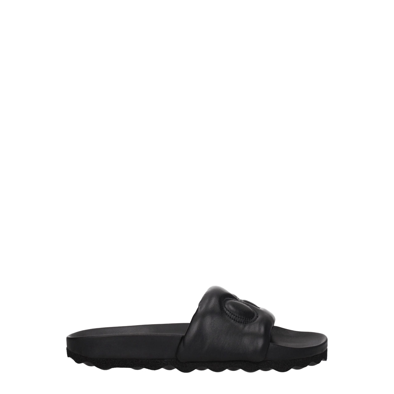 Black slide sandal with padded strap and textured sole on white background