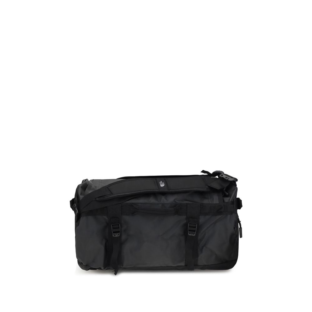 Black waterproof duffel bag with padded shoulder strap and buckle closures