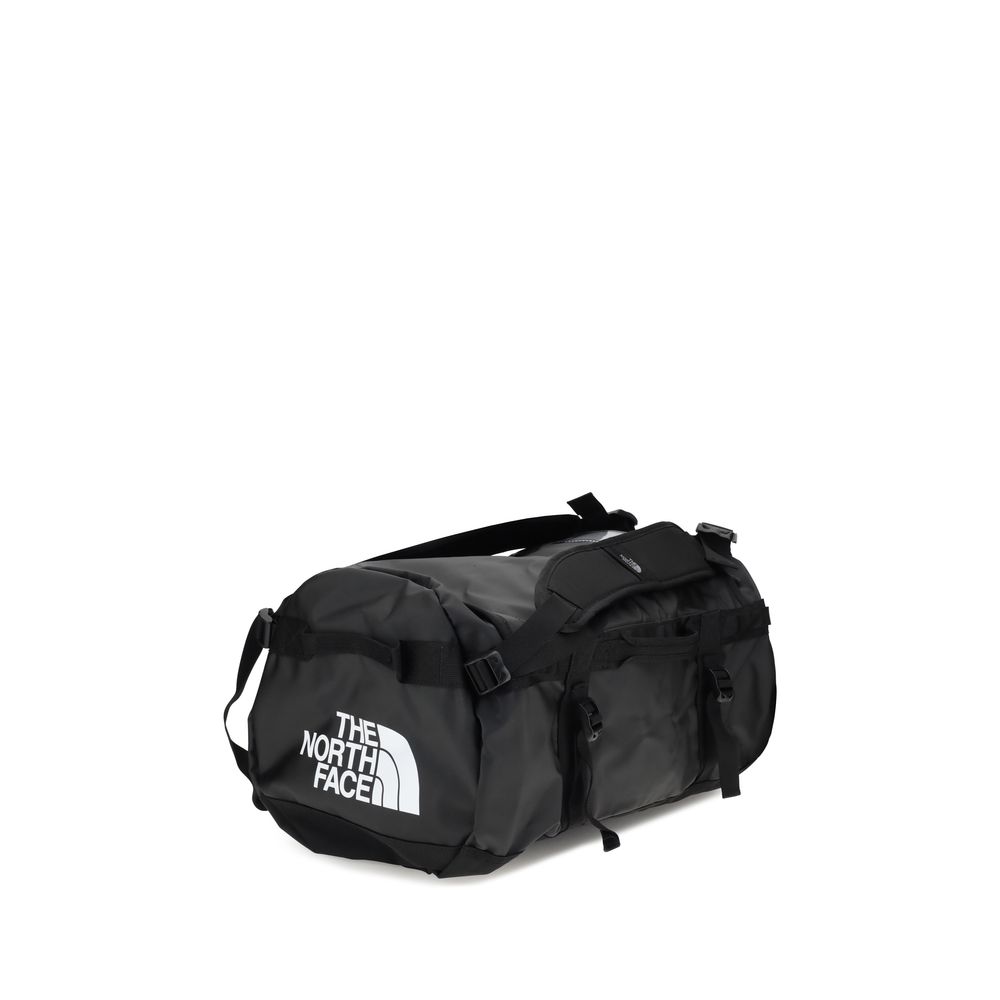Black waterproof duffel bag with padded shoulder strap and buckle closures