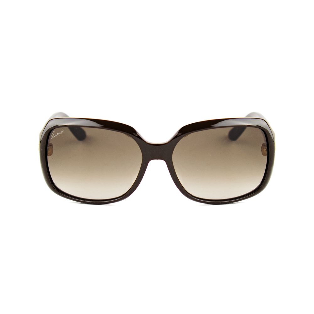 Black Gucci sunglasses with gradient brown lenses and gold logo on textured temples