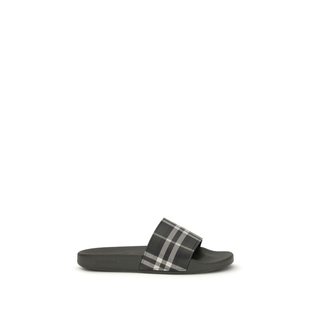 Black slide sandal with gray and white plaid strap on white background