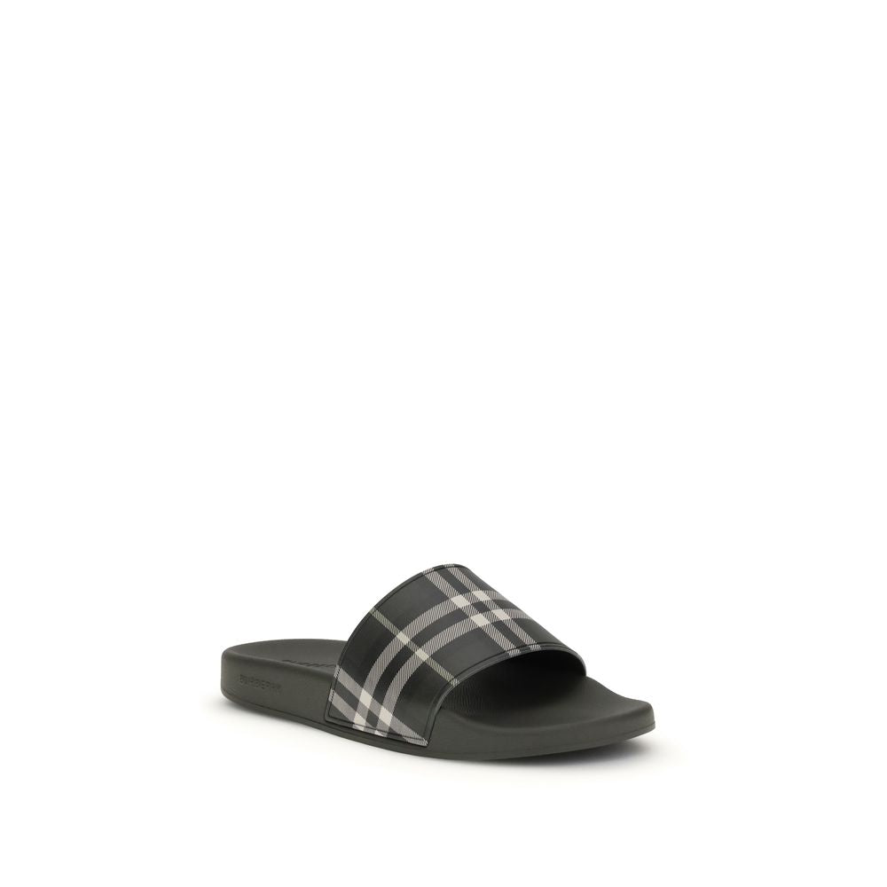 Black slide sandal with gray and white plaid strap on white background