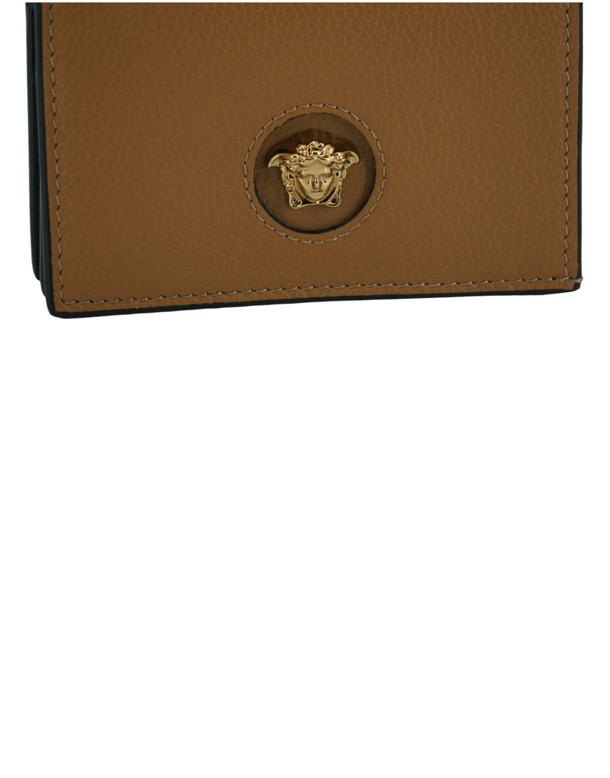 Brown leather wallet close-up with gold Medusa emblem and detailed stitching