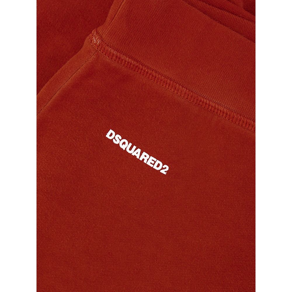 Close-up of burnt orange fabric with white DSQUARED2 logo on stitched garment
