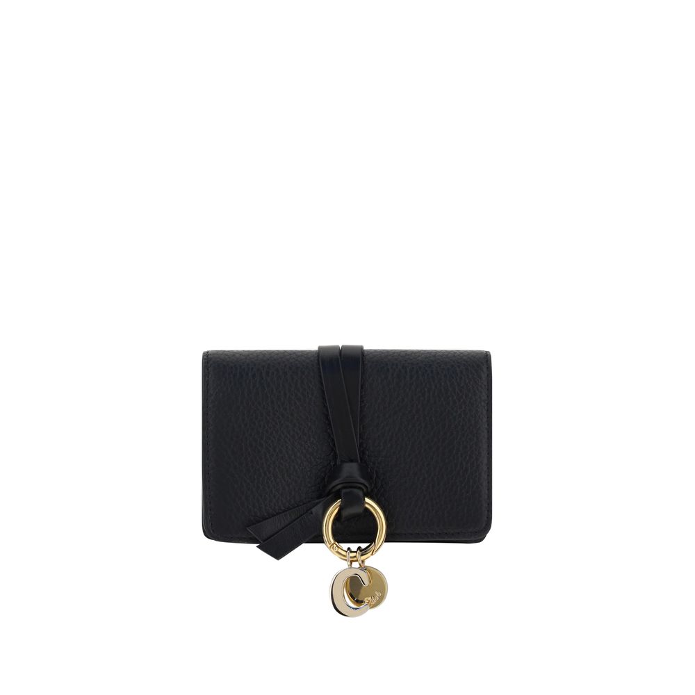 Black leather wallet with textured finish and gold charm detail on front