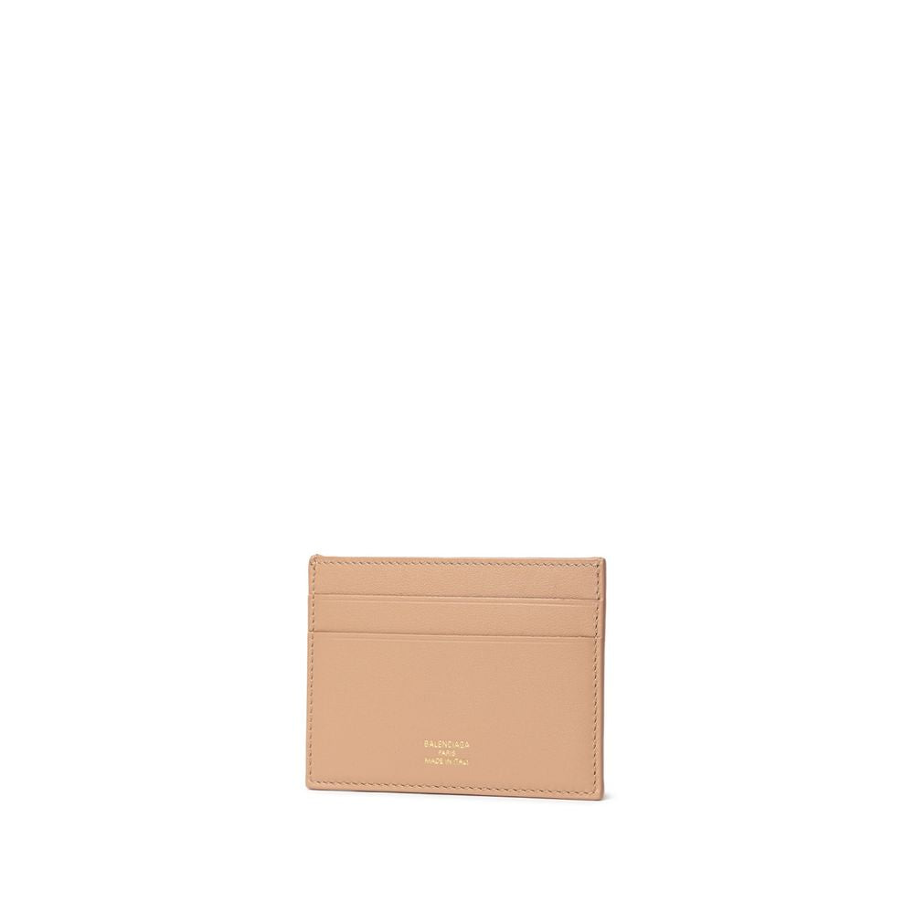 Beige leather card holder with Balenciaga Paris logo embossed in gold on white background