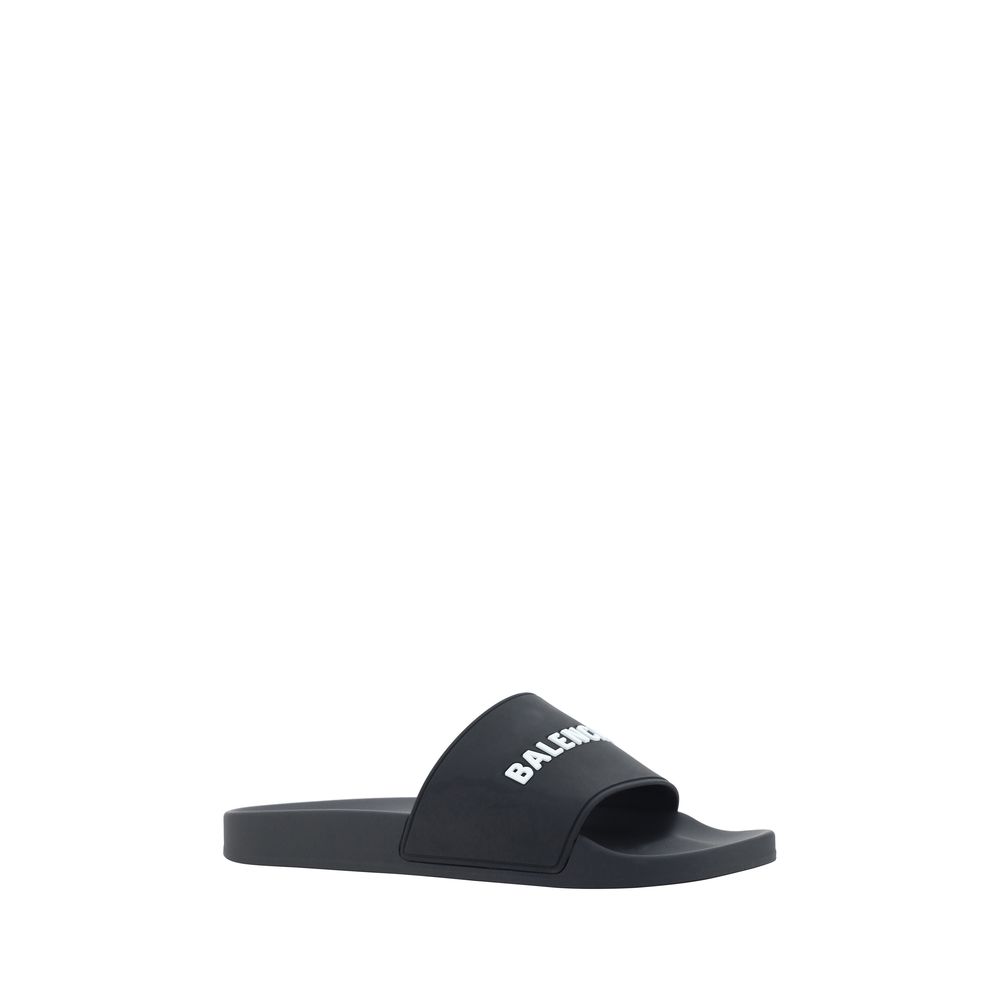 Black Balenciaga branded slide sandal with white logo on strap isolated on white