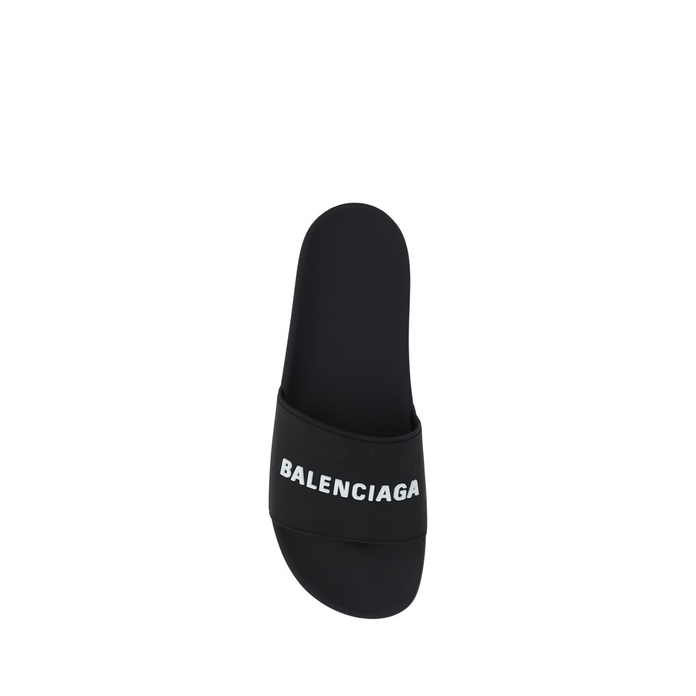 Black Balenciaga slide sandal with white logo on strap, isolated on white background