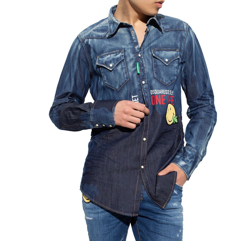 Man wearing blue denim long-sleeve shirt with front pockets and colorful patches on white background