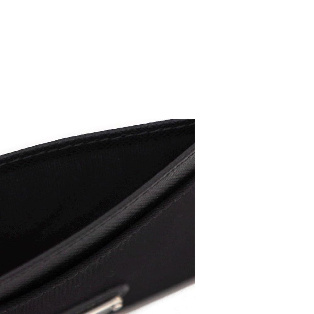 Close-up of a black leather wallet interior with visible stitching and compartments