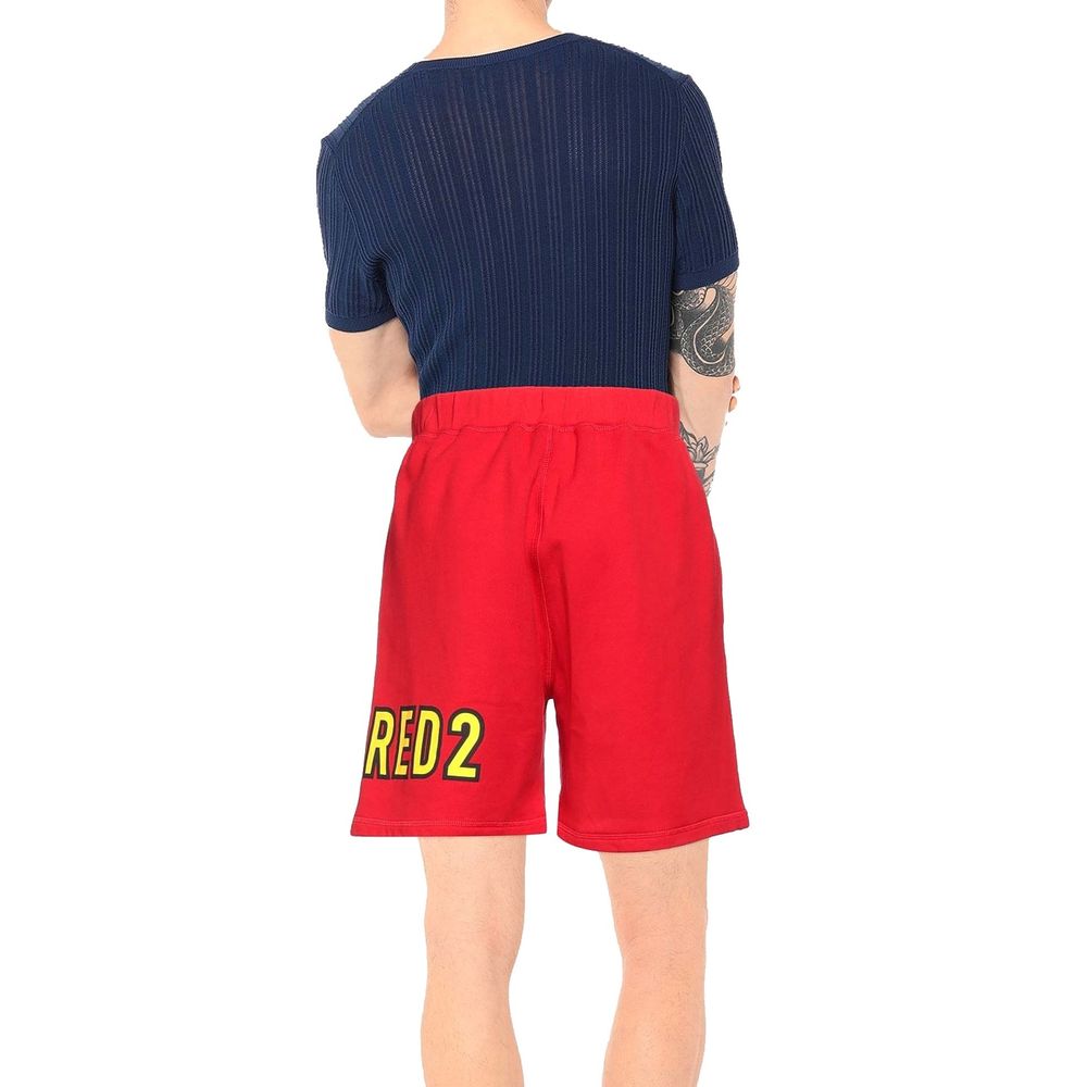 Man wearing red shorts with yellow RED 2 print and navy blue ribbed short-sleeve shirt, back view