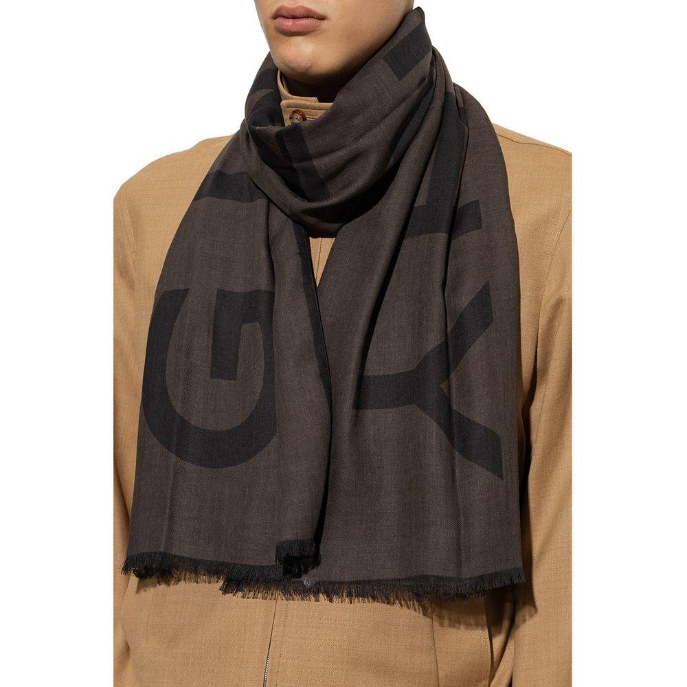 Close-up of man wearing black and brown logo print scarf with fringed edges and tan jacket