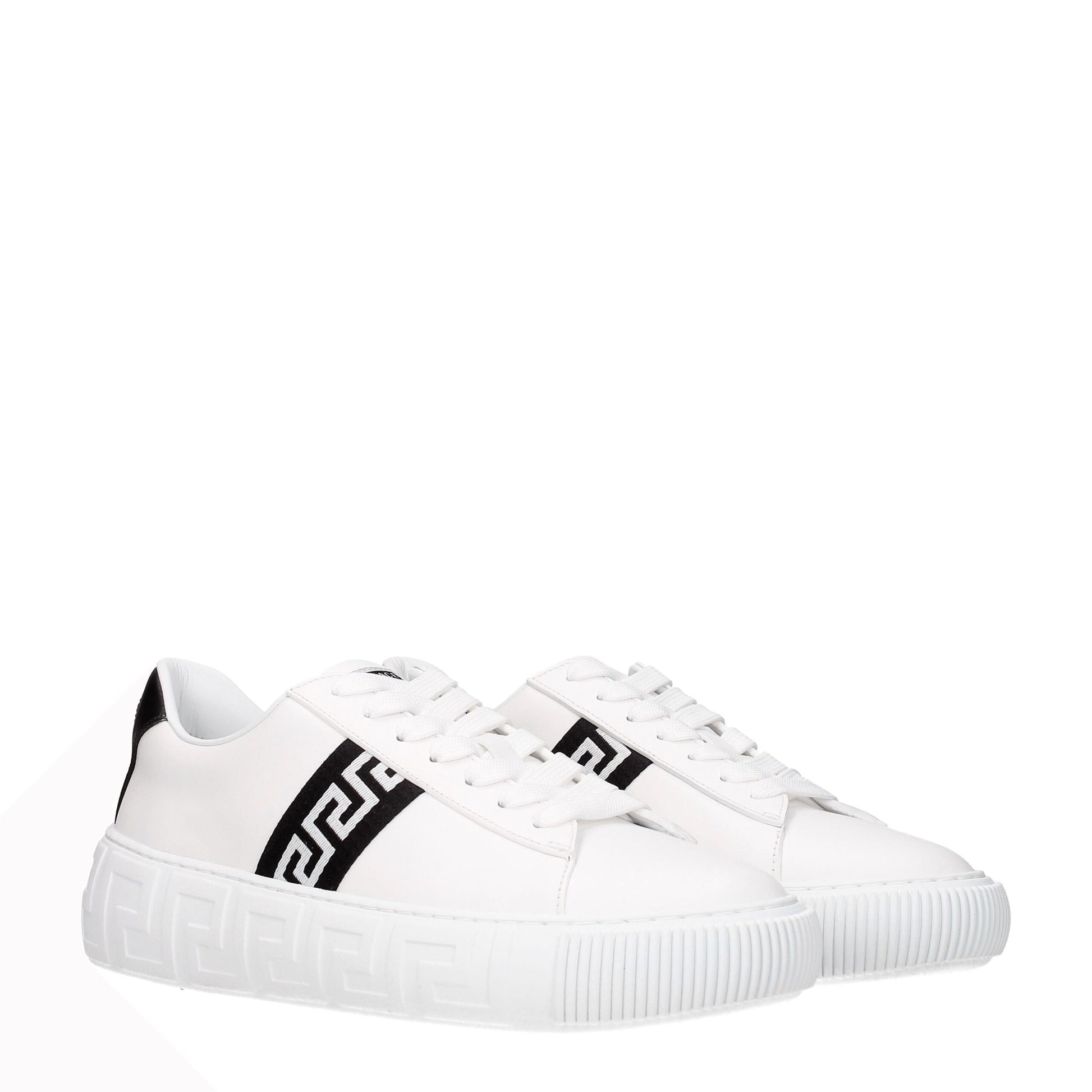 White leather sneakers with black geometric stripe and embossed Greek key pattern sole