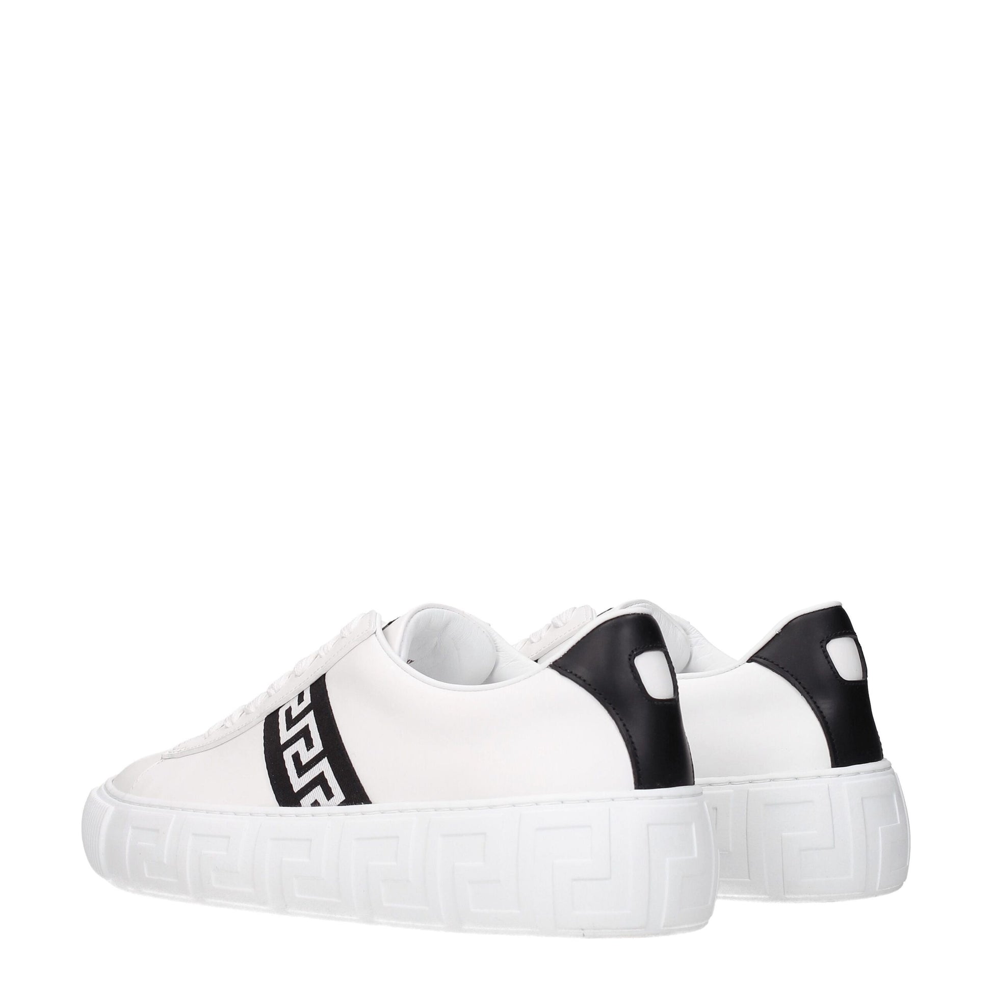 White platform sneakers with black geometric stripe and black heel tab on white background