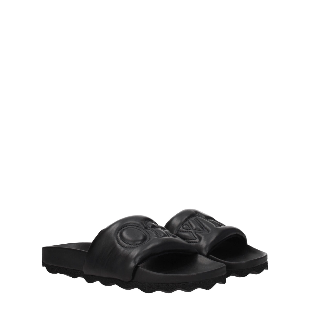 Black slide sandal with padded strap and textured sole on white background