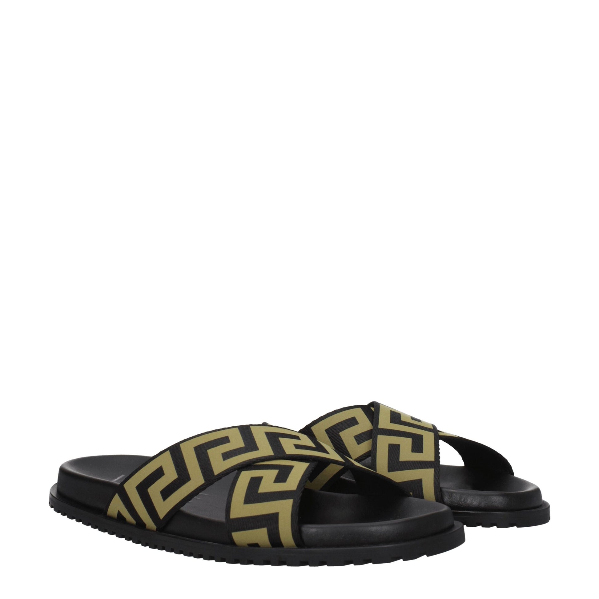 Black slides with gold geometric patterned crisscross straps on white background
