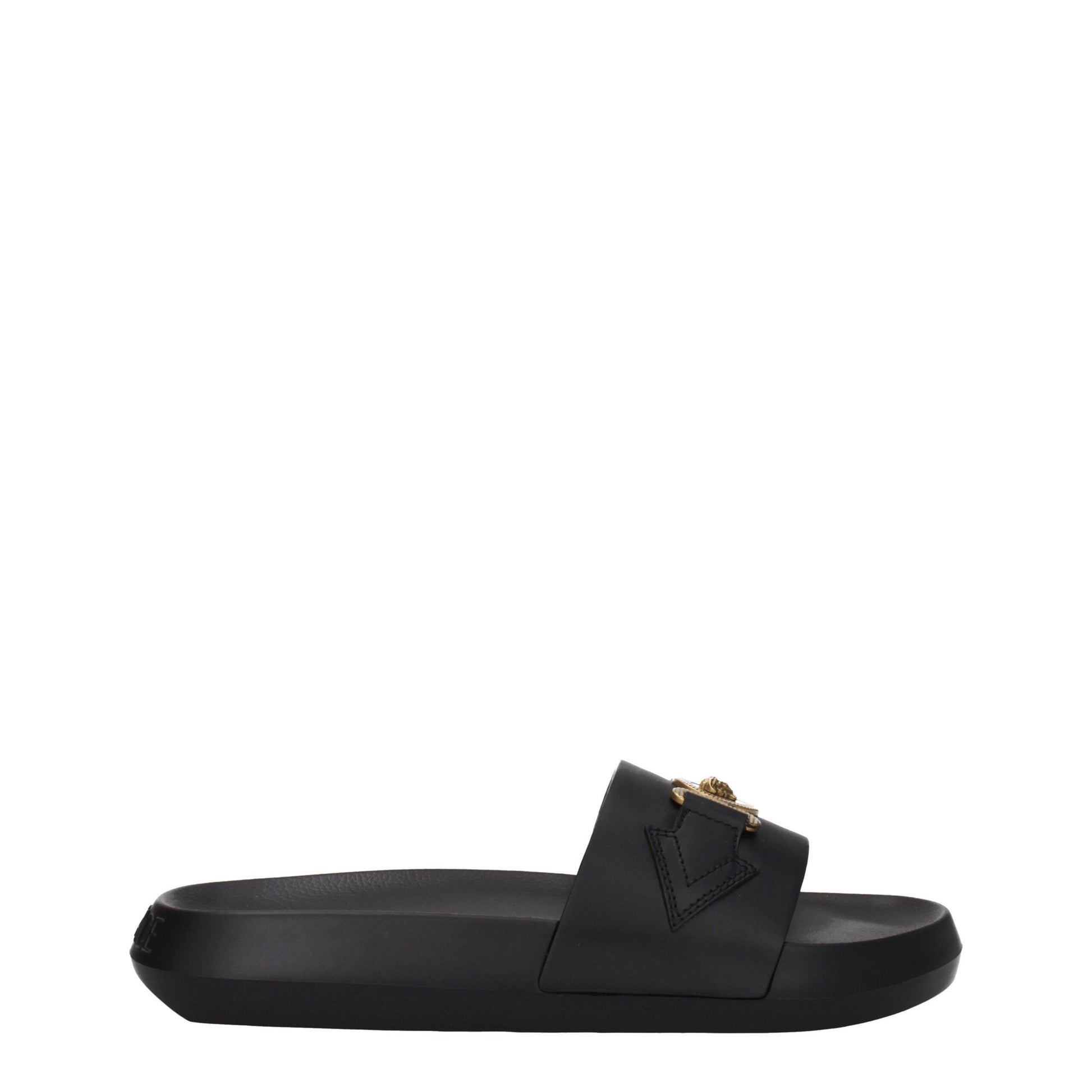 Black slide sandal with thick sole and gold-tone lion head embellishment on wide strap