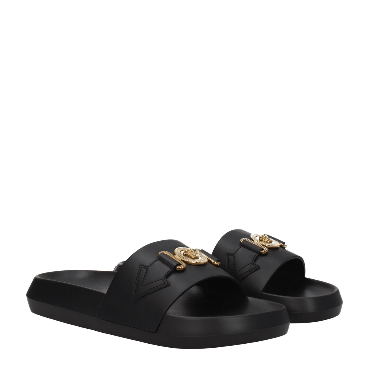 Black slide sandal with thick sole and gold-tone lion head embellishment on wide strap