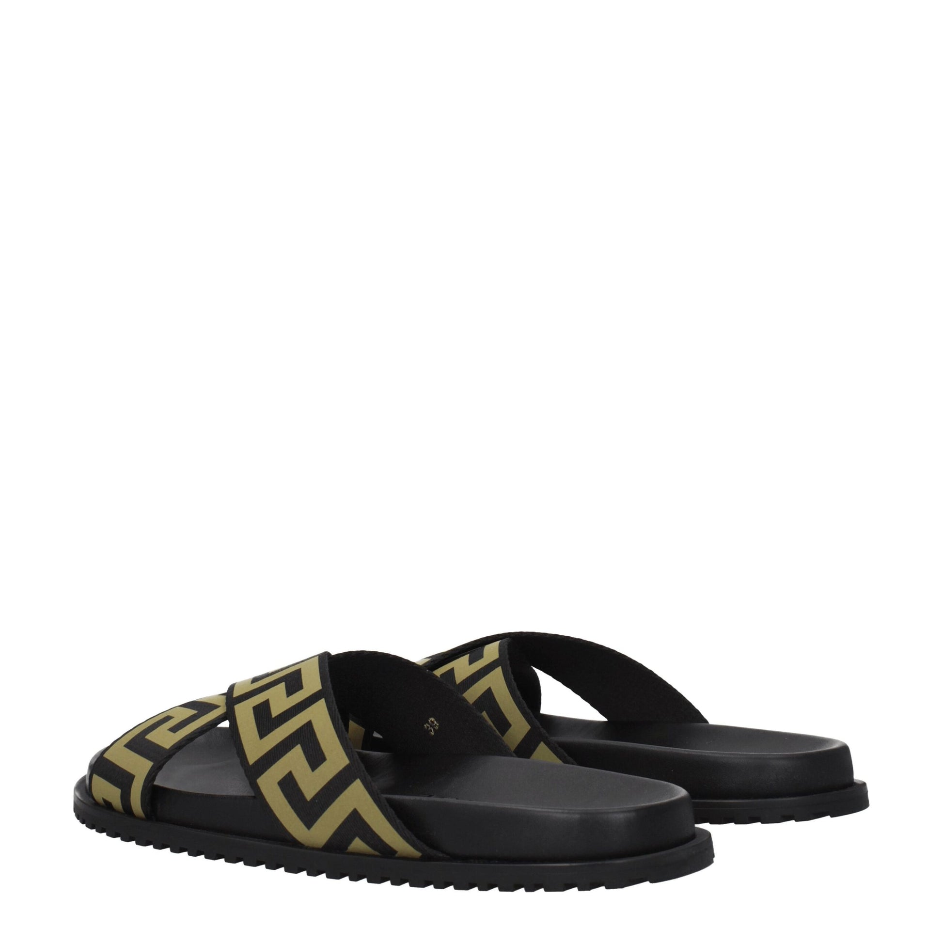 Black slide sandals with gold geometric pattern straps and textured soles