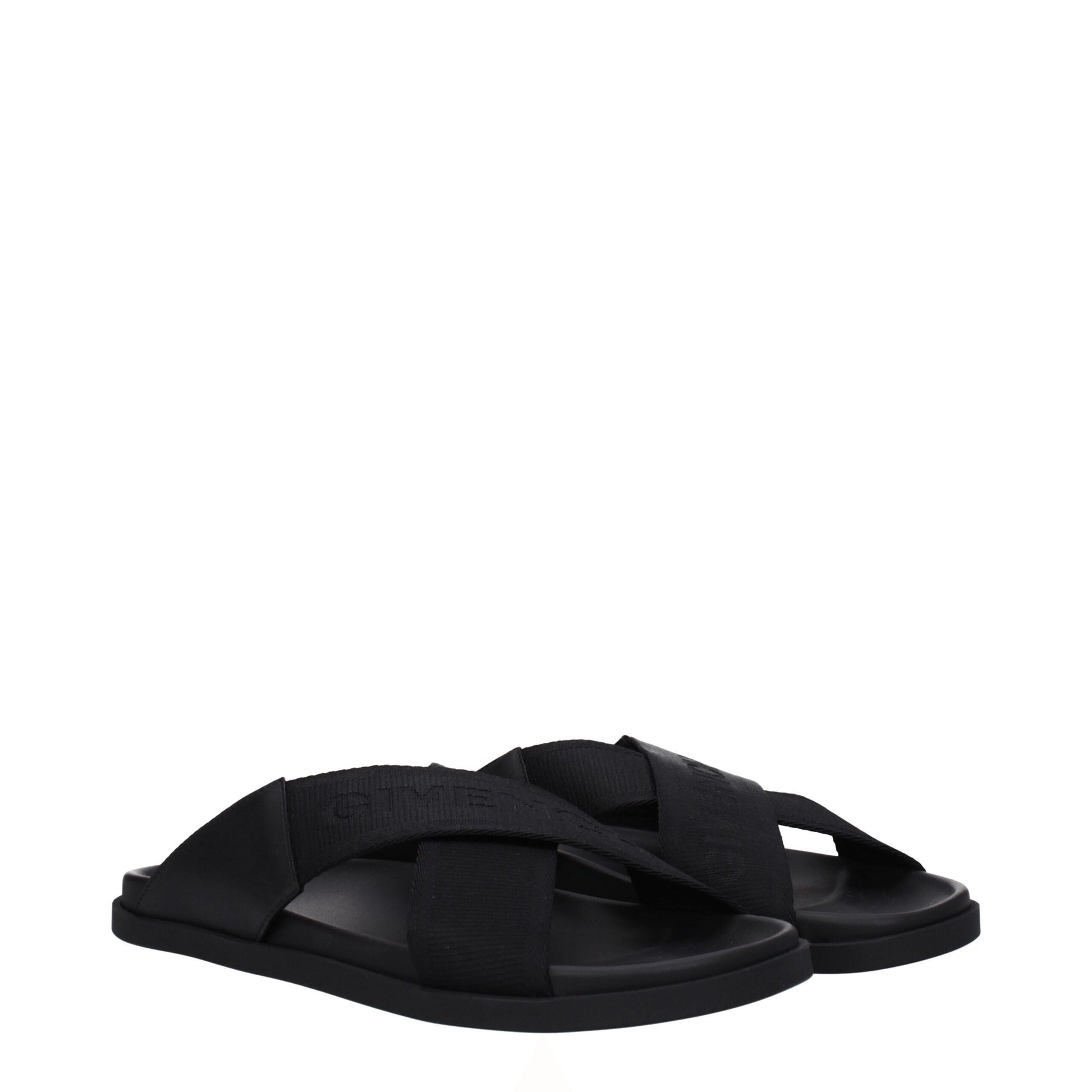 Black slide sandals with wide crisscross elastic straps and cushioned sole on white background