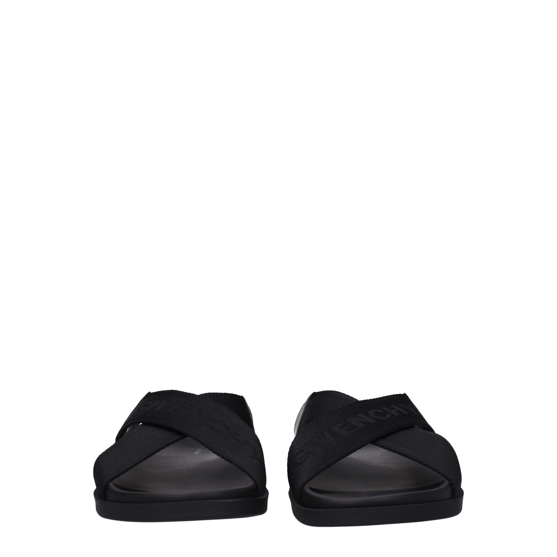 Black Givenchy sandals with crossed straps and logo detailing on a white background