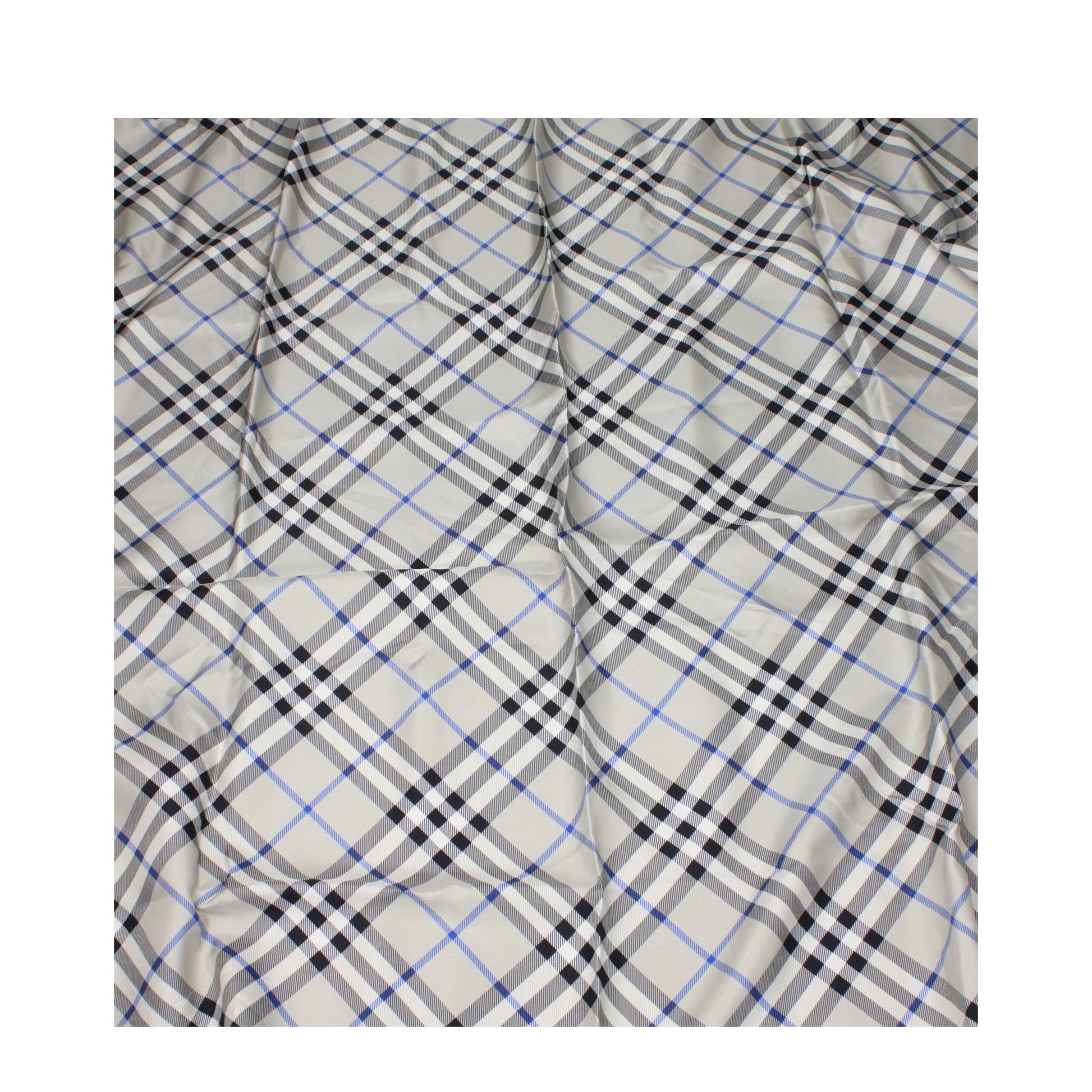 Soft fabric with classic beige, black, and blue plaid pattern, slightly wrinkled textile