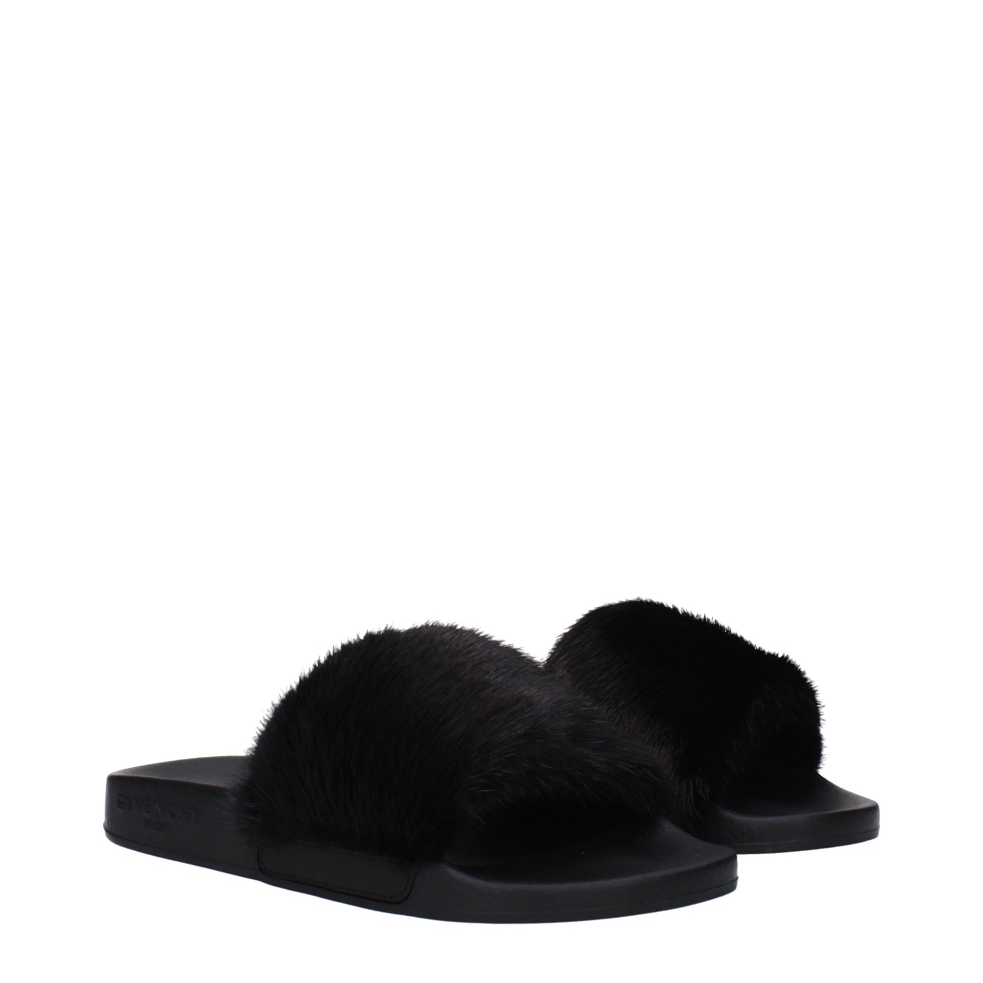 Black luxurious fur slides with flat sole and open toe on white background