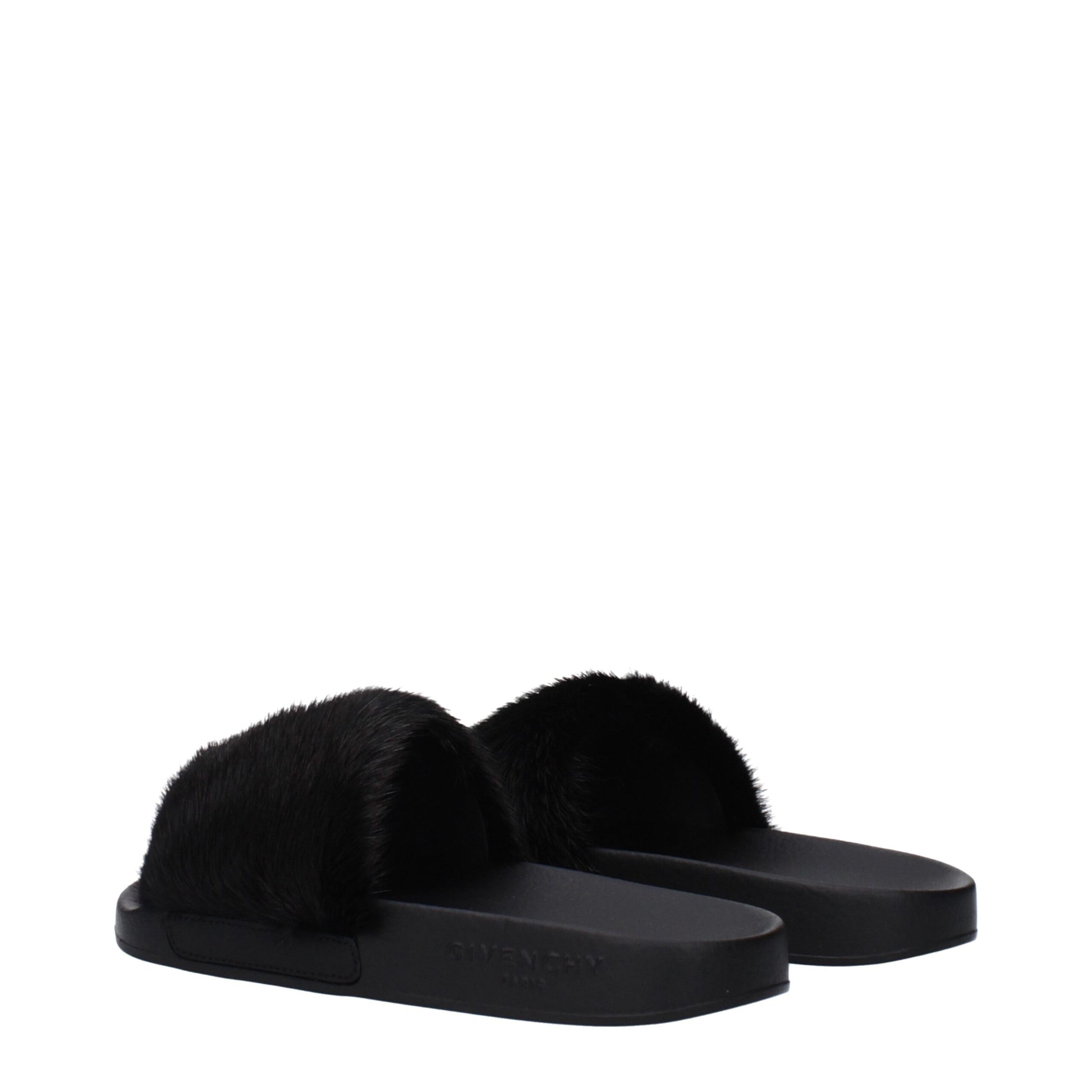 Black Givenchy slides with plush faux fur strap and rubber sole on white background