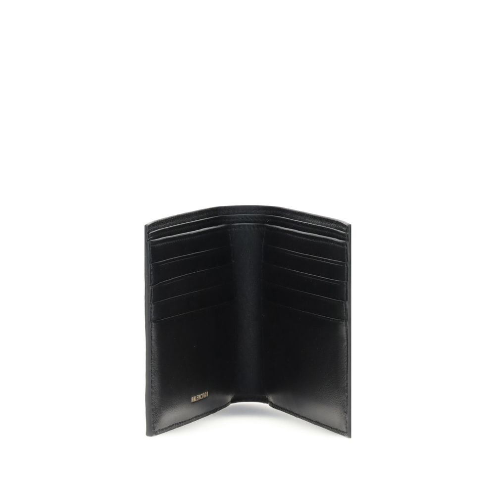Open black leather Balenciaga wallet with multiple card slots inside on white background