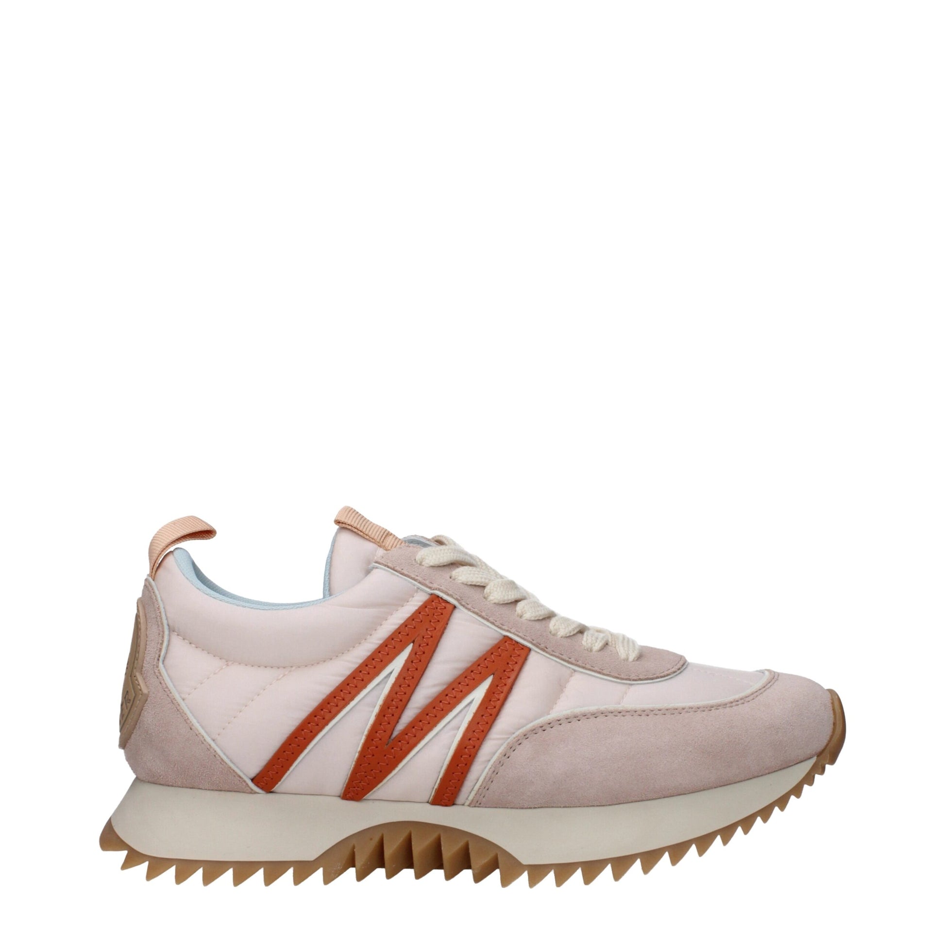 Side view of pink and beige casual sneaker with zigzag sole and orange accent on white background