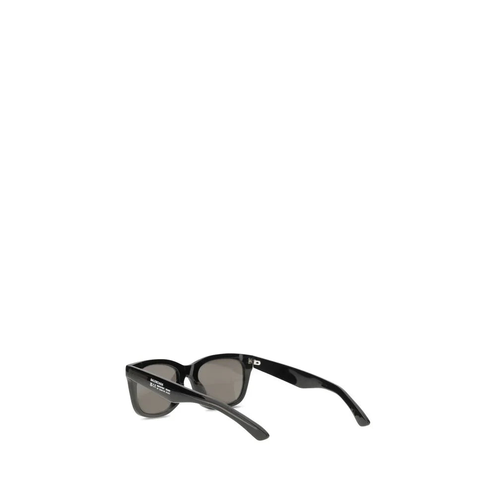 Black Balenciaga sunglasses with dark lenses and thick plastic frame on white background