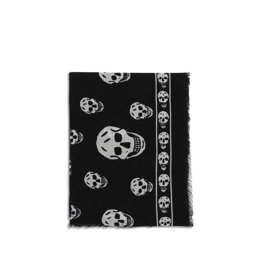 Black scarf with white skull pattern and frayed edges folded neatly