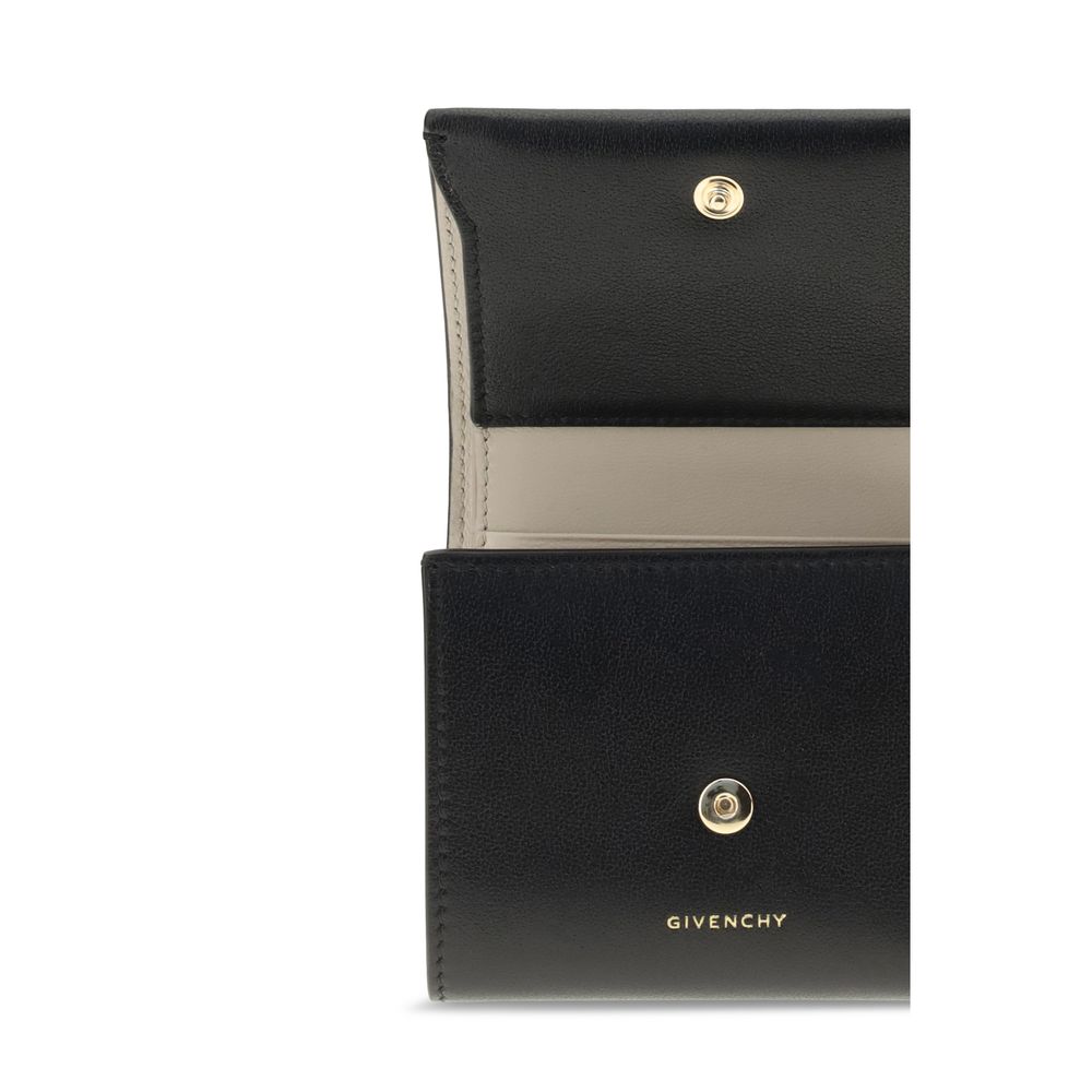 Open black Givenchy leather wallet with beige interior and gold snap buttons