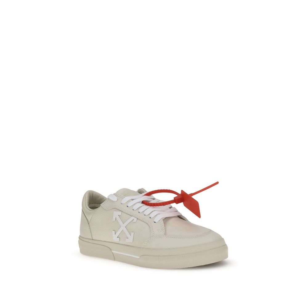 Off-white low-top sneaker with white arrows logo and red zip tie tag on white background