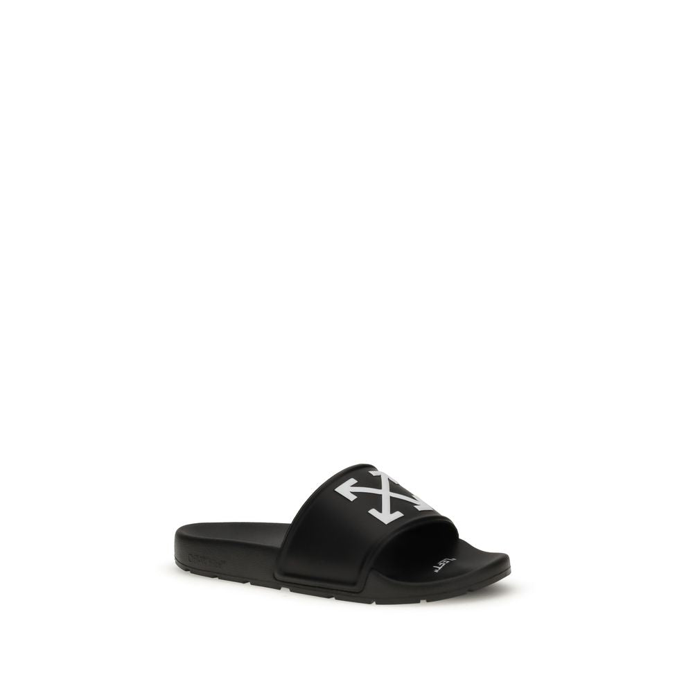 Black slide sandal with white arrow logo on strap and contoured footbed on white background