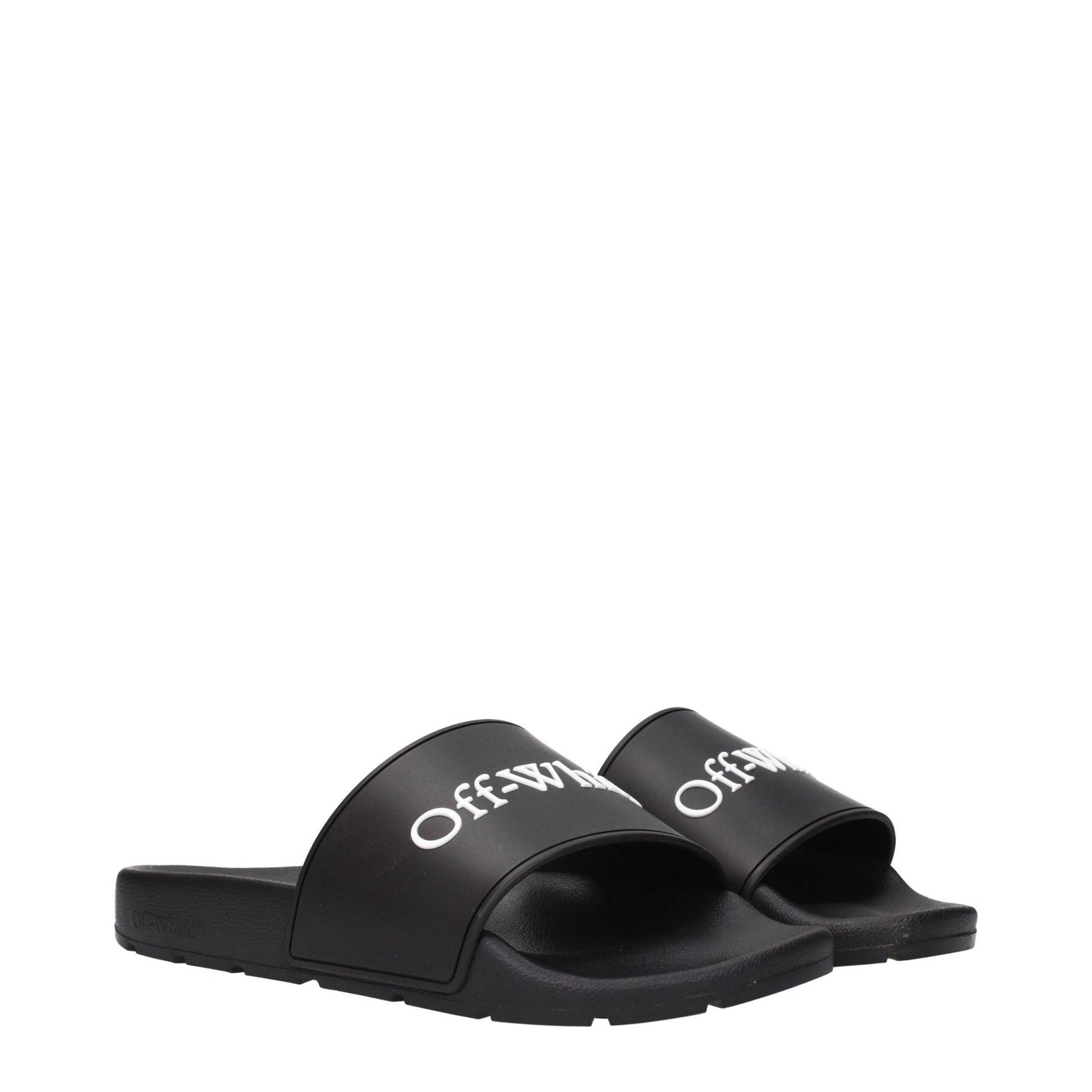 Black Off-White rubber slides with white logo text on top straps, isolated on white background