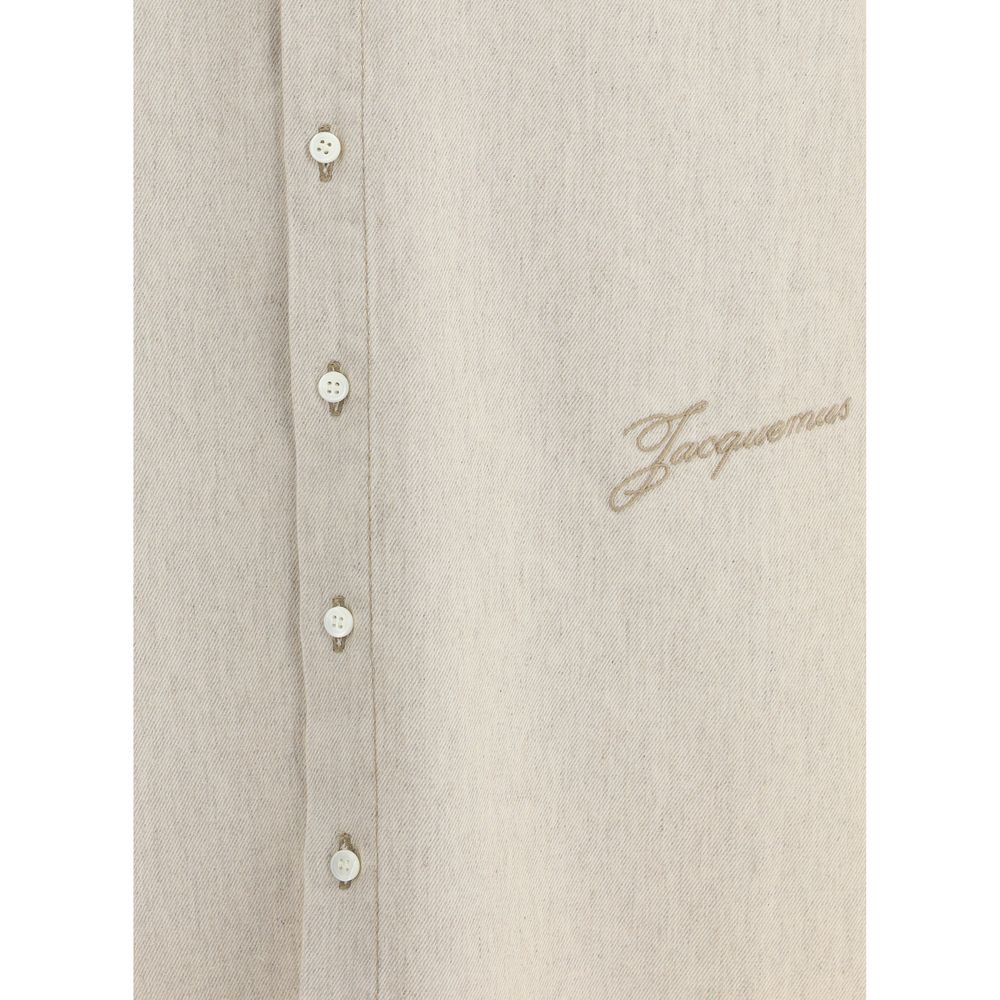 Beige button-up shirt with white buttons and tan embroidered Jacquemus logo