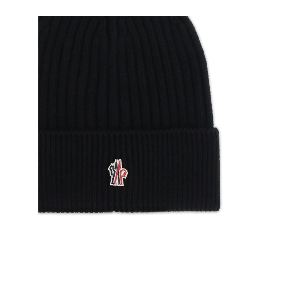 Black ribbed knit beanie hat with folded cuff and small red, white, and black Moncler logo patch
