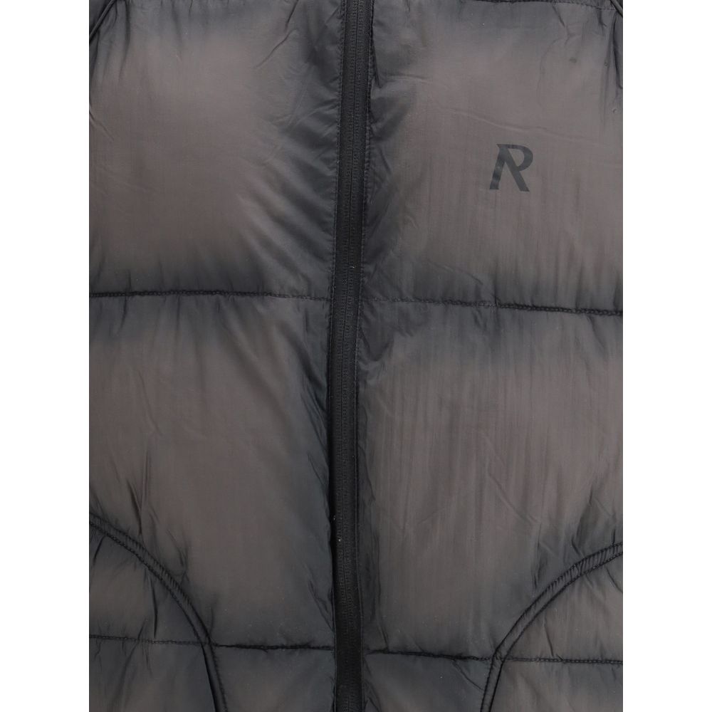 Close-up of black quilted jacket with central zipper and R logo on chest