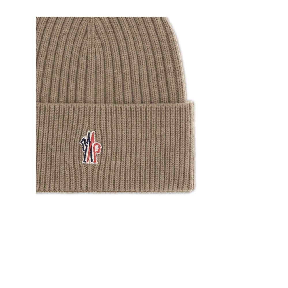 Beige ribbed knit beanie with folded cuff and embroidered red, white, and blue logo patch