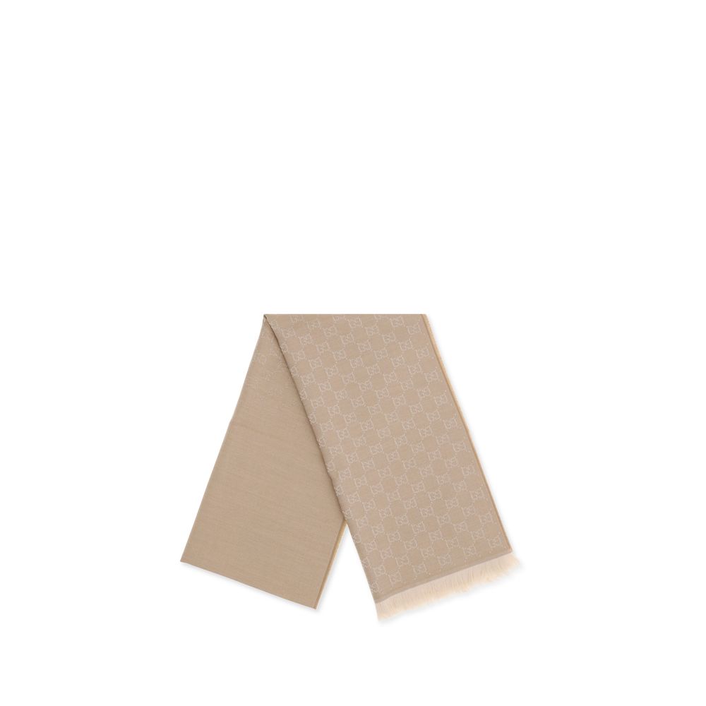 Beige designer scarf with monogram pattern and fringed ends on white background