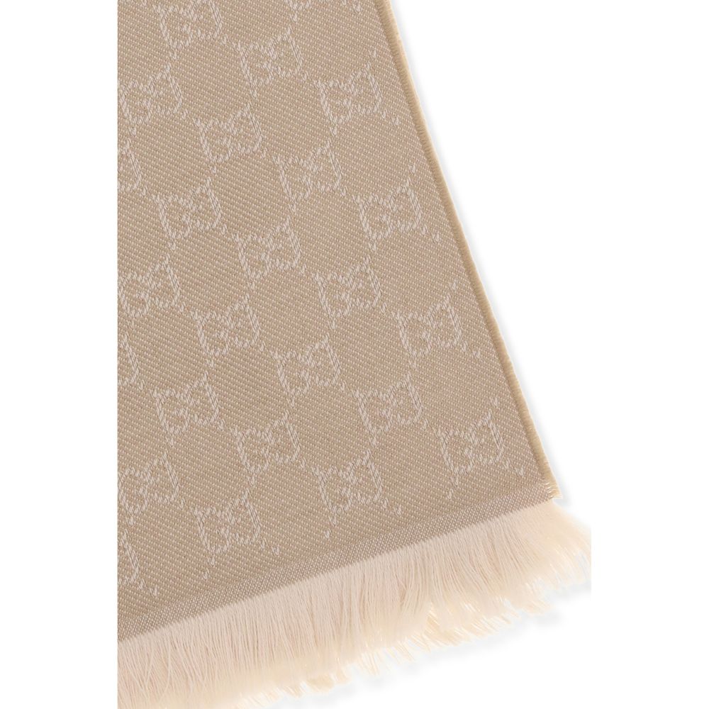 Beige textured fabric scarf with repeating diamond and bow pattern, fringed edge