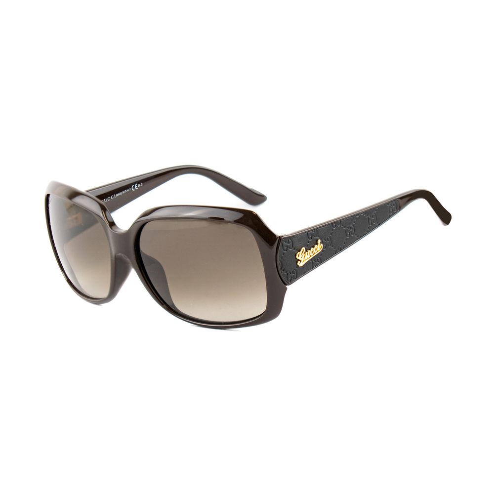 Black Gucci sunglasses with gradient brown lenses and gold logo on textured temples