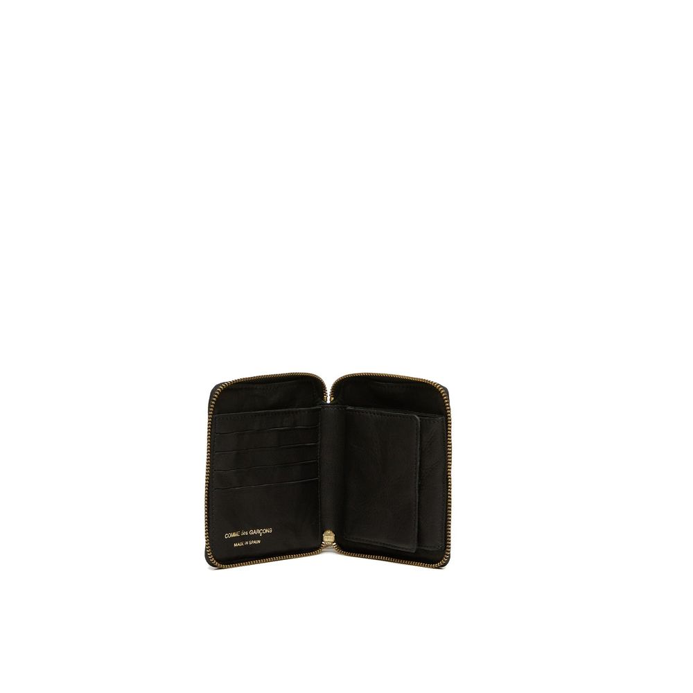 Open black Comme des Garçons leather wallet with zipper and card slots