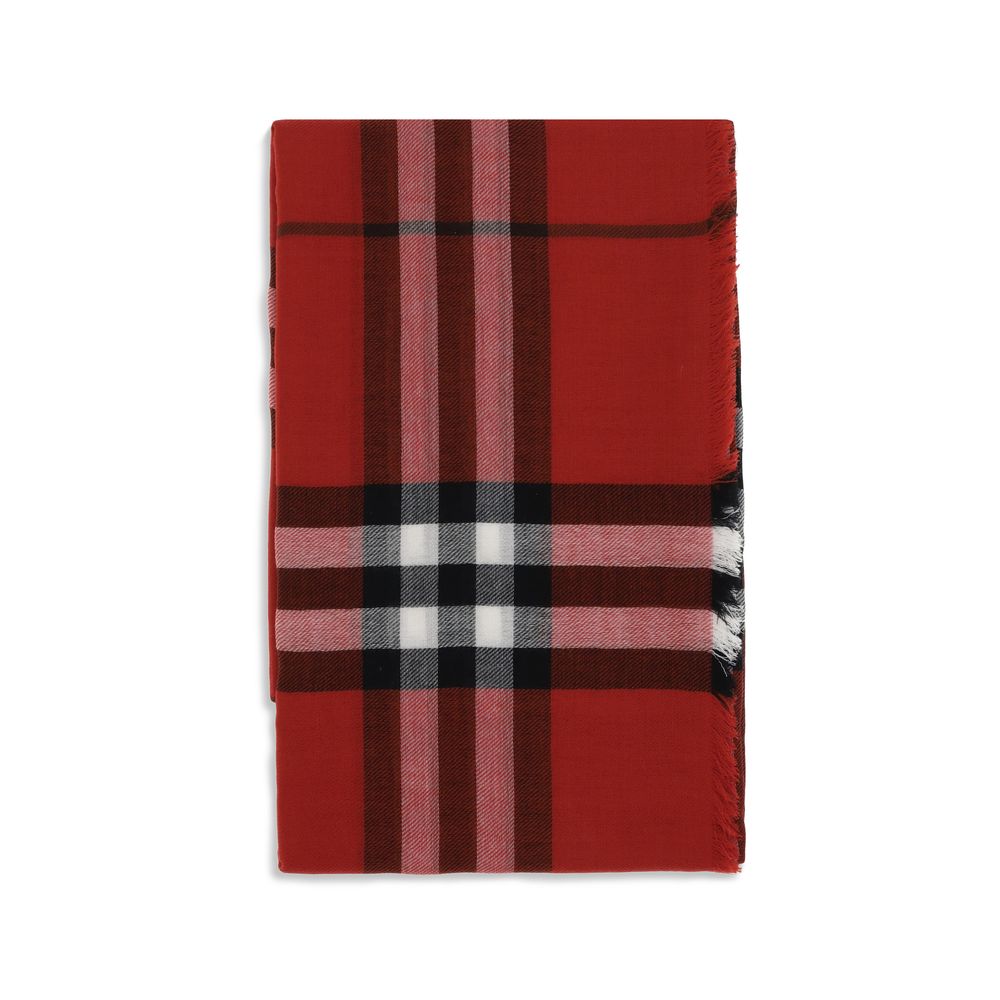 Folded red plaid scarf with black, white, and pink stripes and fringed edges