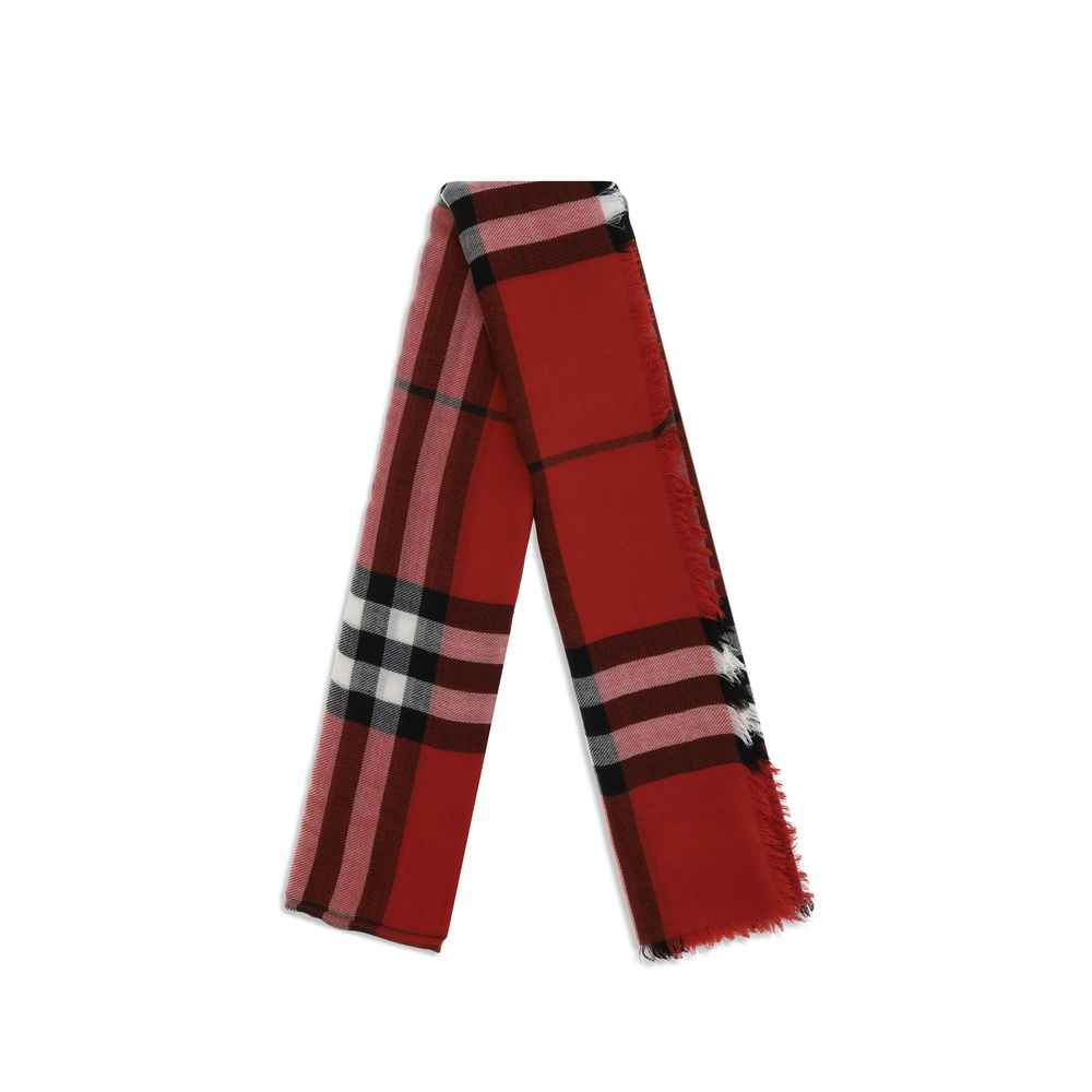 Folded red plaid scarf with black, white, and pink stripes and fringed edges