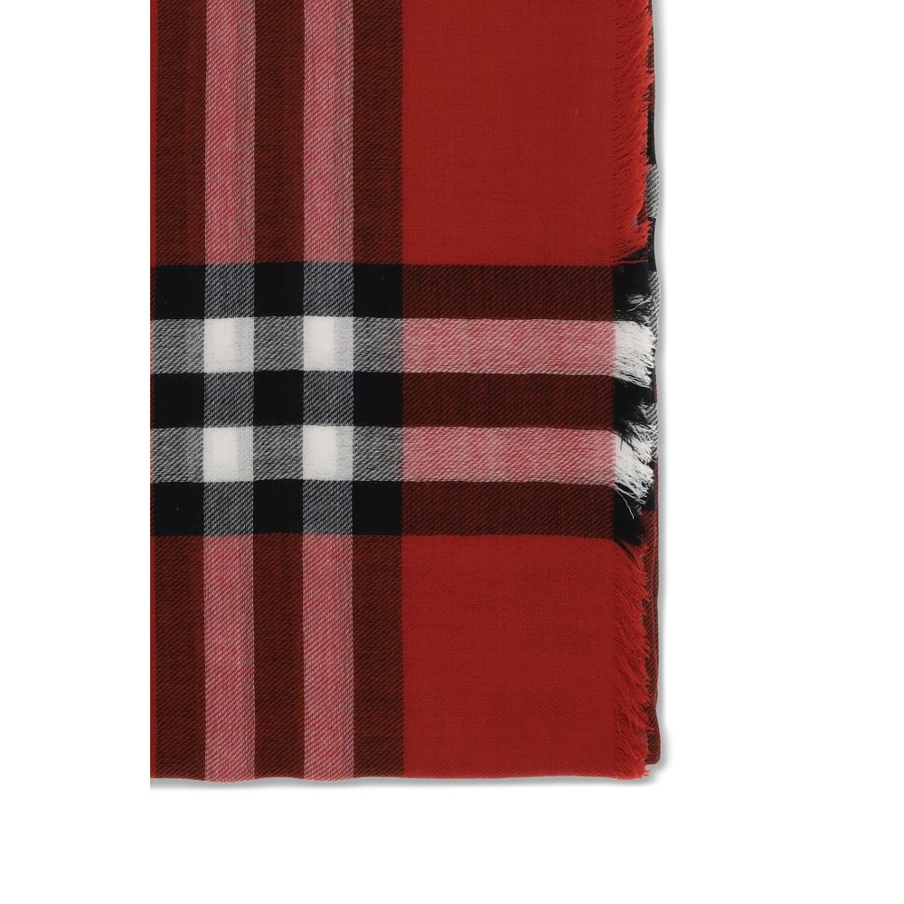 Red plaid scarf with black, white, and pink stripes and fringed edges on white background